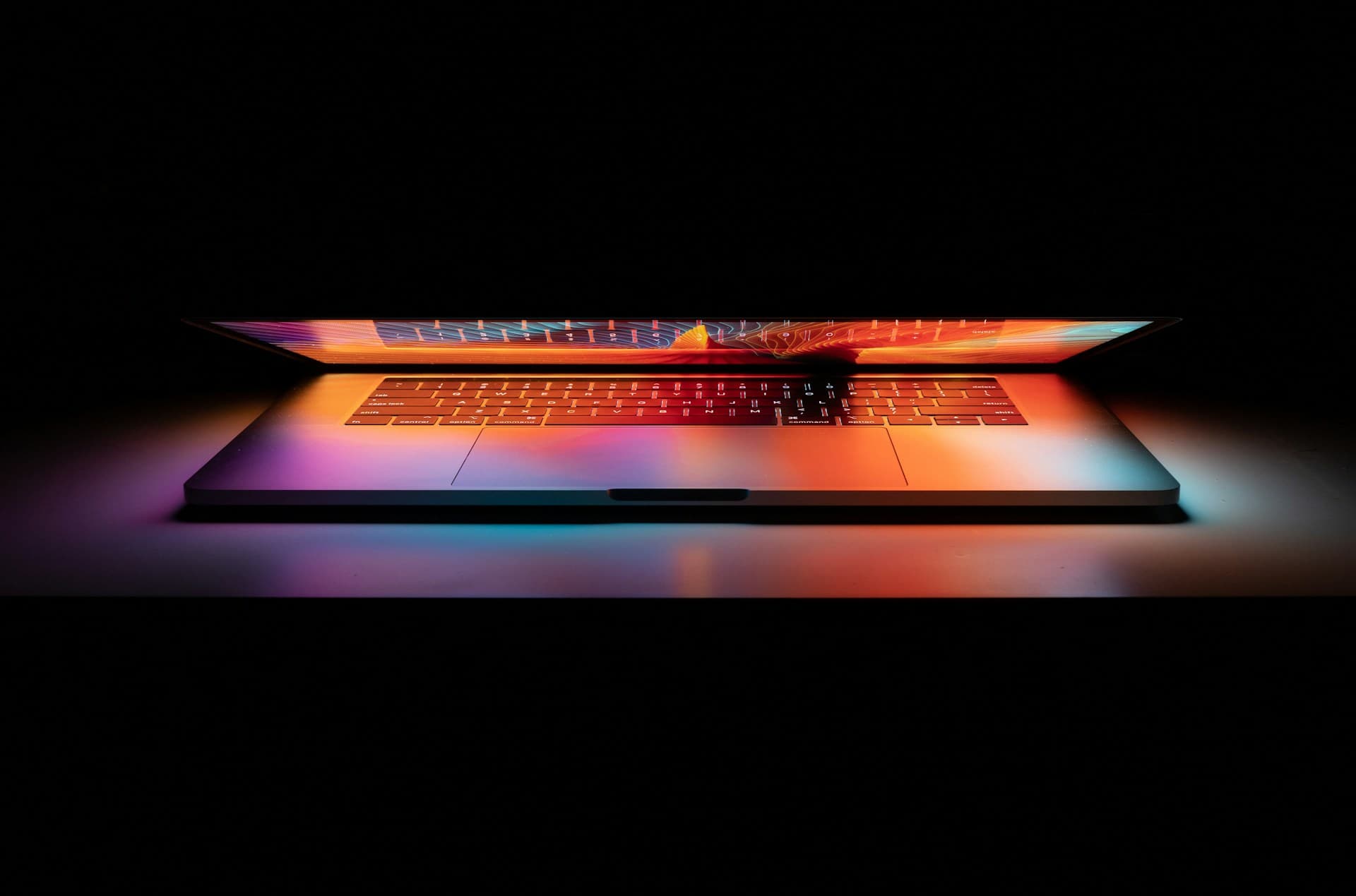 A MacBook Pro open on a white surface